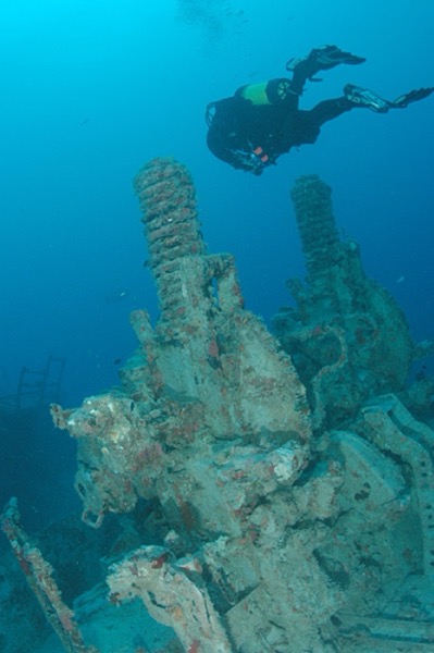 A diver next to a gun mount on the Spiegel Grove wreck
