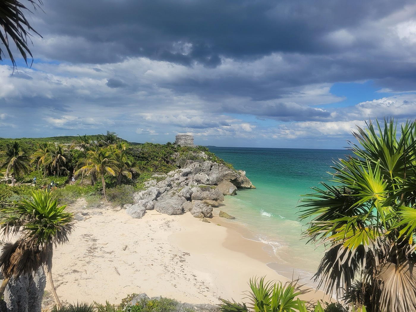 The Maya ruins of Tulum on a cliff above a white-sand beach